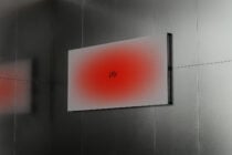Wall display showing red gradient blur fading from vibrant to white with ply branding