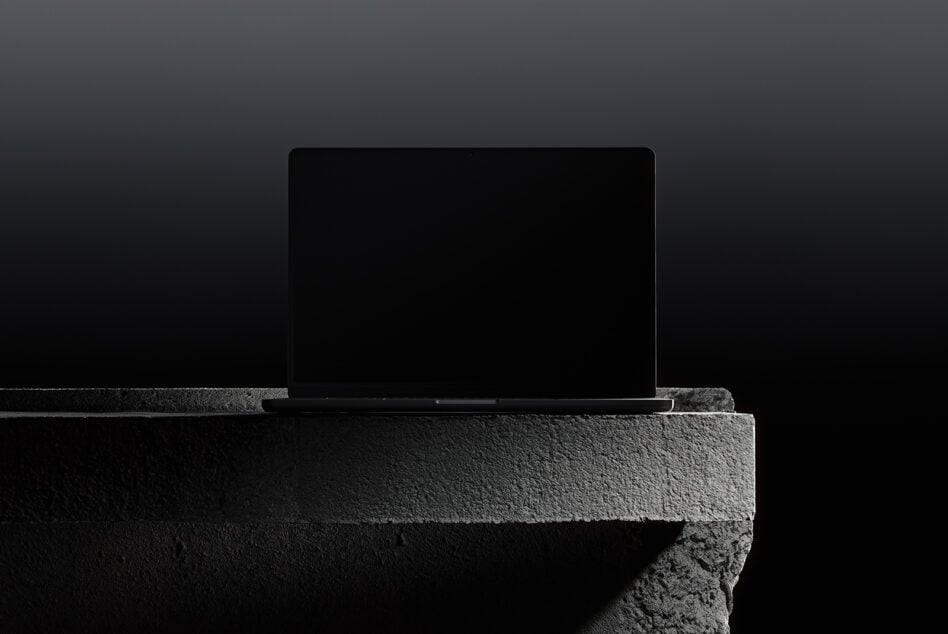 Elegant laptop mockup on textured stone background ideal for designers. Perfect for showcasing digital assets. Keywords: mockup, laptop, designers, digital assets.