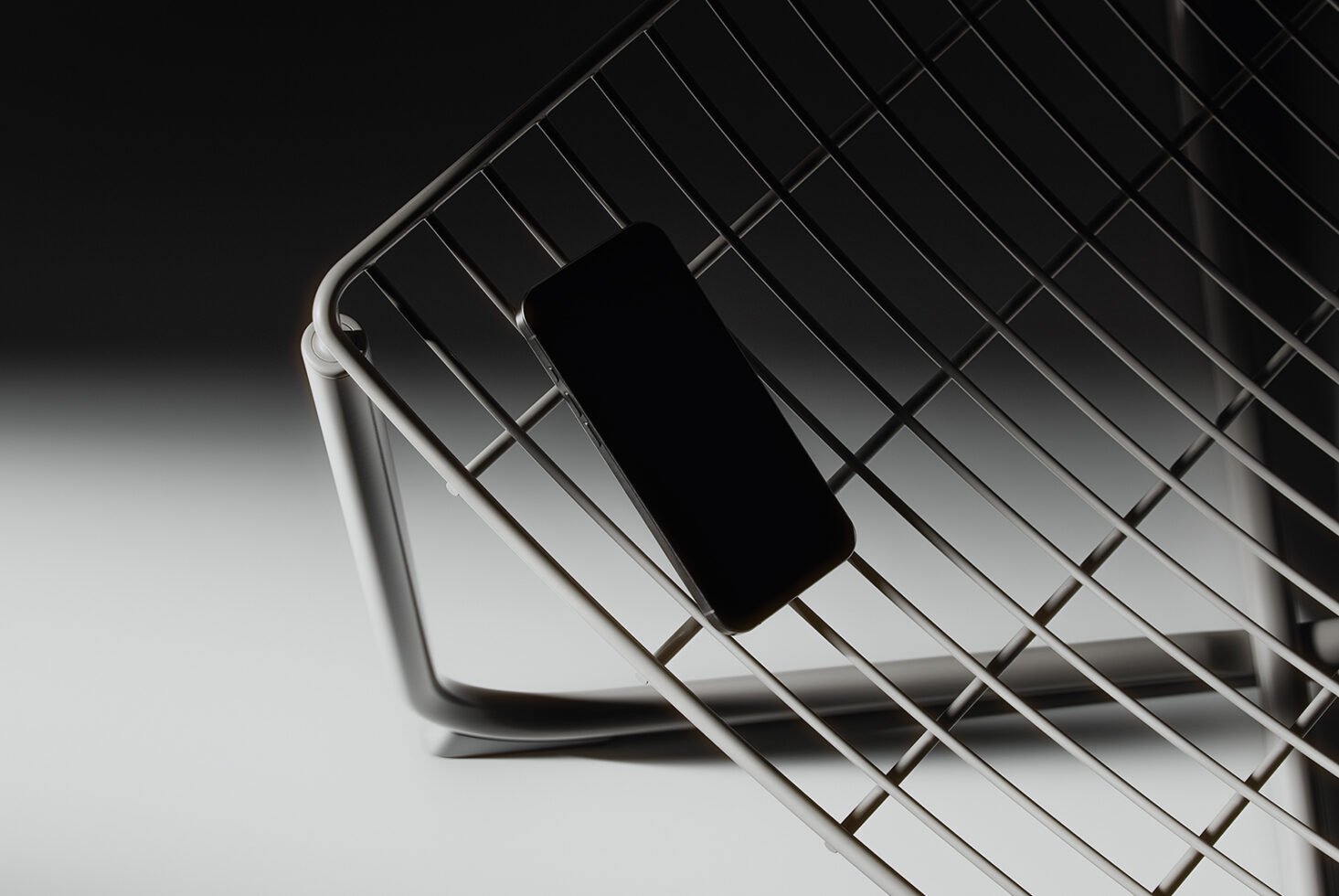 Modern smartphone placed on a sleek wireframe chair with dramatic lighting Mockup ideal for showcasing minimalist design concepts and mobile app interfaces