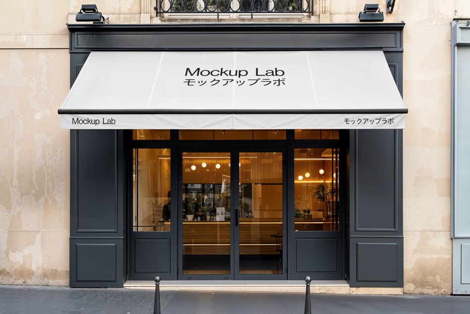 White storefront awning mockup on Parisian facade with warm interior lighting