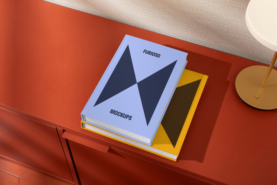 Mockup book cover designs in blue and yellow on a red table. Perfect for designers seeking high-quality, modern book mockups for projects or presentations.