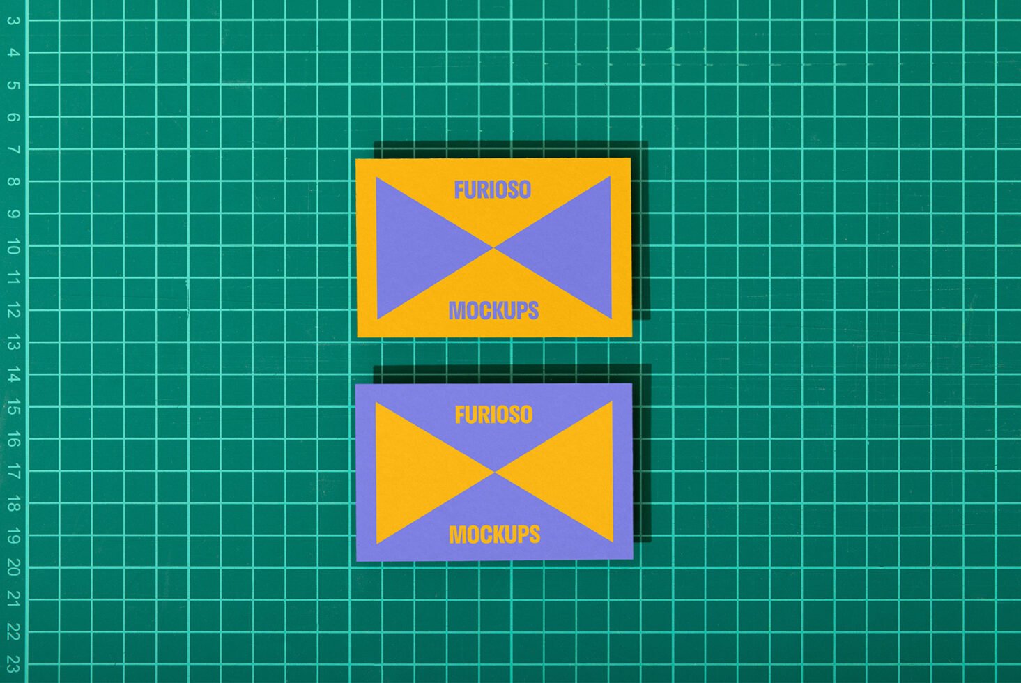 Business card mockup on green cutting mat background for designers. Bright colors. Ideal for showcasing designs. Keywords: mockup, template, card.