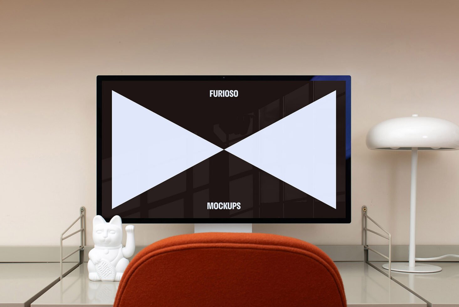 Desktop workspace with a modern computer displaying a mockup design. Features contemporary decor including a desk lamp and a Japanese lucky cat figurine.