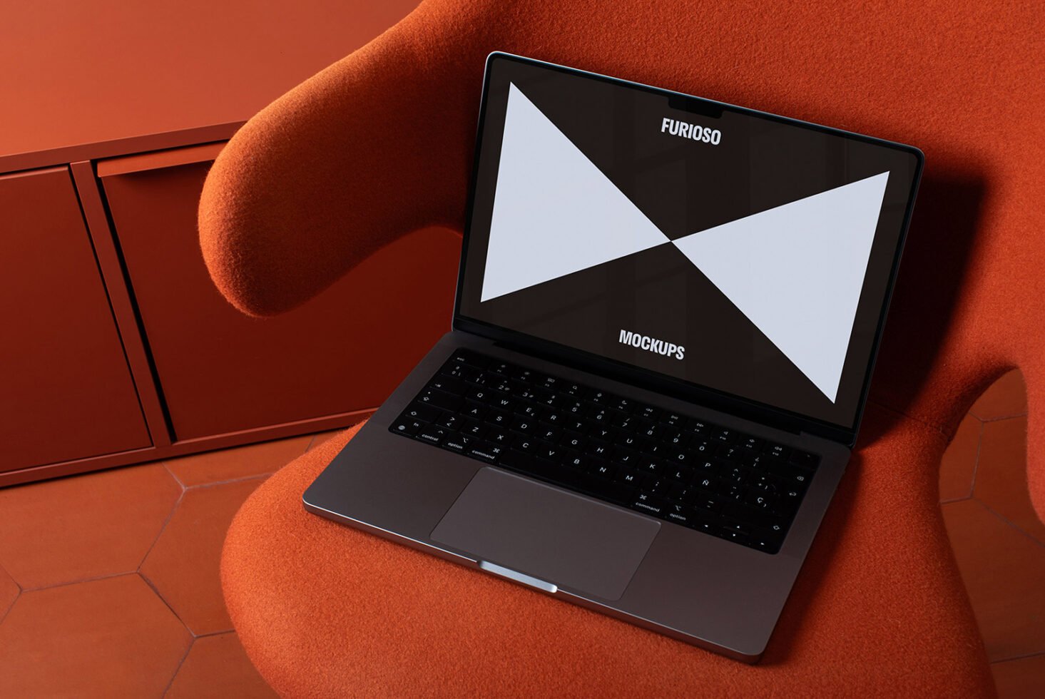 Open laptop on an orange chair showcasing a geometric mockup on screen. Ideal for designers seeking stylish templates. Tech design inspiration.