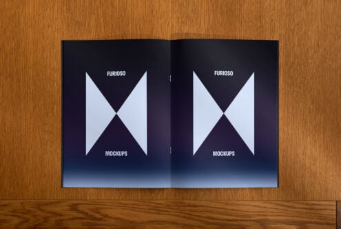 Open mockup book on a wooden surface showing a clean geometric design. Ideal for designers seeking modern and minimalist template presentation.