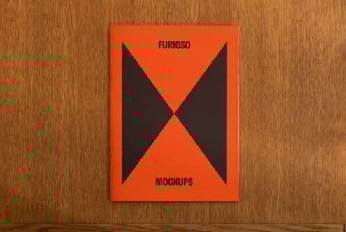 Orange mockup template cover with a bold black triangle design on a wooden surface. Ideal for graphic designers, digital assets, and design inspiration.