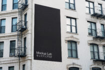 Dark billboard mockup on brick building showing Mockup Lab branding