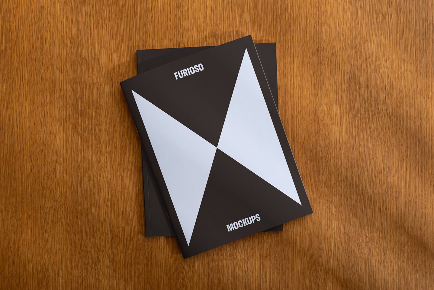 Modern book cover mockup on wooden surface featuring bold geometric design, ideal for showcasing graphic design projects in professional portfolios.