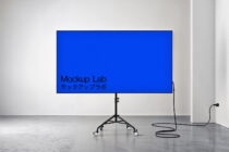 Widescreen display mockup on rolling stand in white room with blue background option
