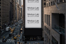 Daytime billboard mockup on city block with repeating text, yellow taxis below