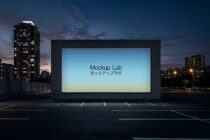 Urban billboard at sunset showing blue gradient design with Japanese text overlay