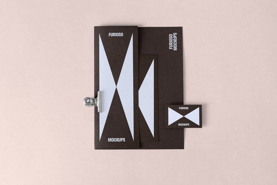 Stylish stationery branding mockup set with a minimalistic design template featuring blue geometric shapes on dark paper. Perfect for design presentations.