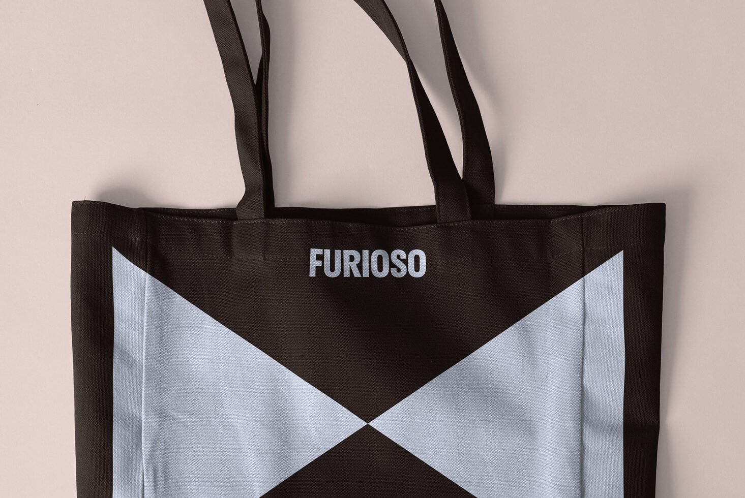 Tote bag mockup with bold geometric design and text branding. Ideal for graphic design projects, templates. Perfect for designers and marketers.