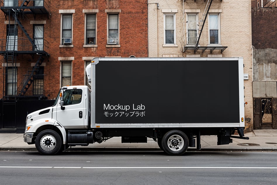 White delivery truck with black mockup template on side parked on urban street. Ideal for showcasing design graphics vehicular advertising.