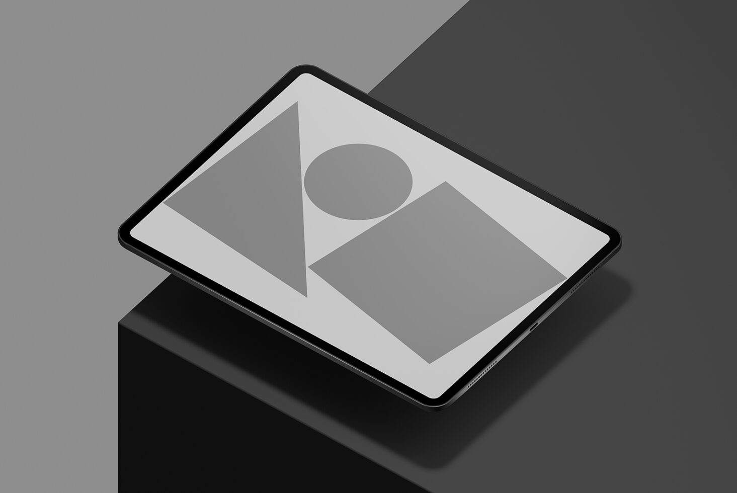 Tablet mockup with geometric shapes on screen, angled on dark surface. Perfect for showcasing digital graphics and templates for designers.
