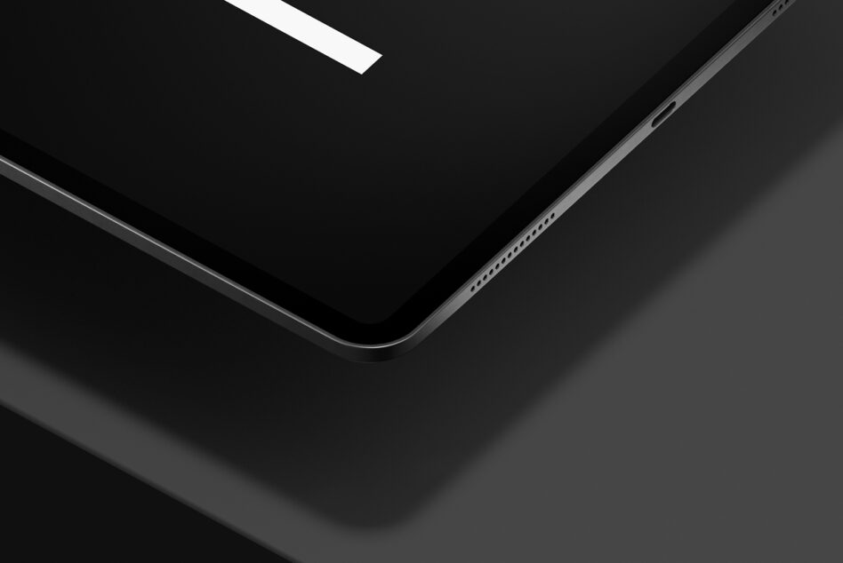 Close up angled view of tablet edge with minimal branding detail visible