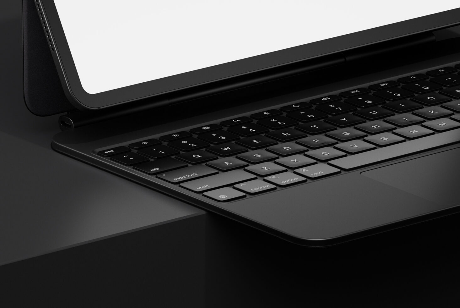 Black tablet device with blank white screen on dark surface