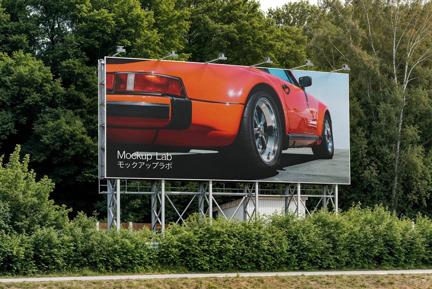 Outdoor billboard mockup featuring a red sports car set against lush greenery ideal for advertising designers seeking realistic presentation templates.
