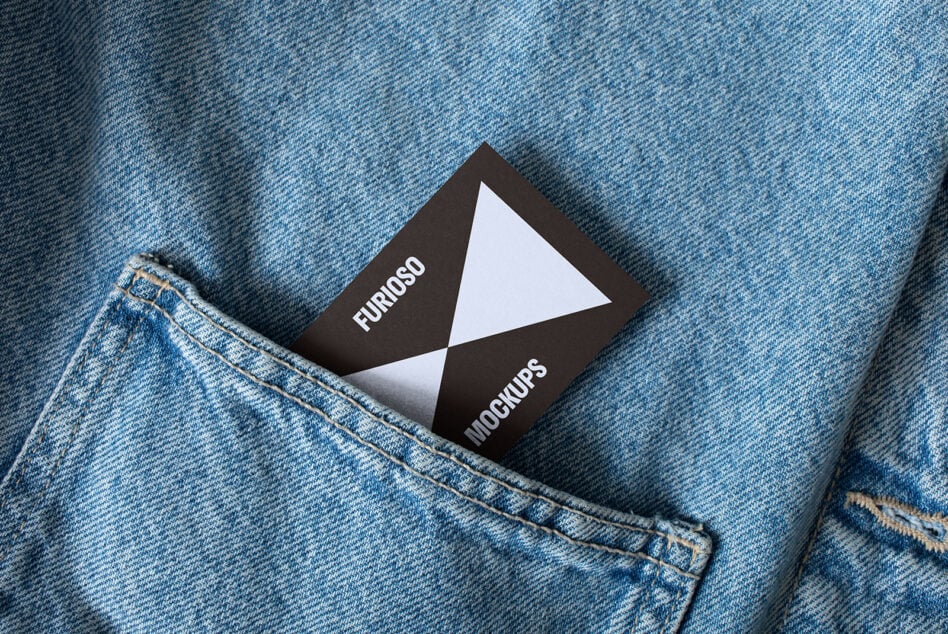 Business card mockup featuring modern black and white design placed in blue denim pocket perfect for designers seeking stylish branding presentations