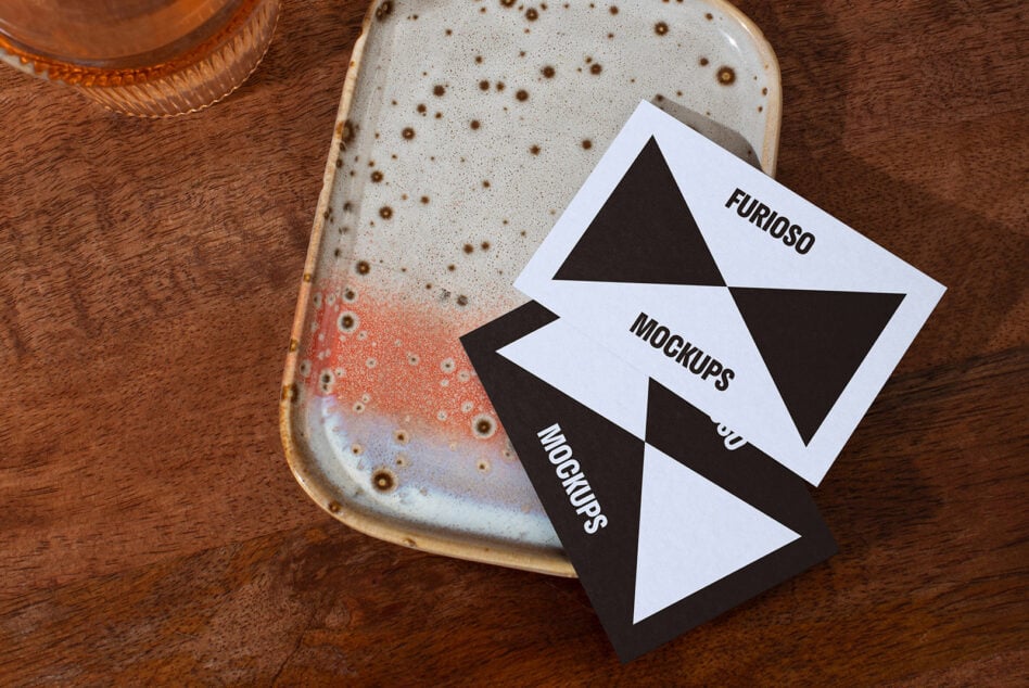 Business card mockups on a ceramic dish. Ideal for designers. Keywords: mockups, business cards, design assets, templates, branding.