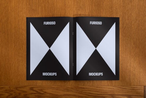 Open brochure mockup on wood surface featuring geometric design in black and white. Ideal for showcasing magazine layouts. Graphic design, template.