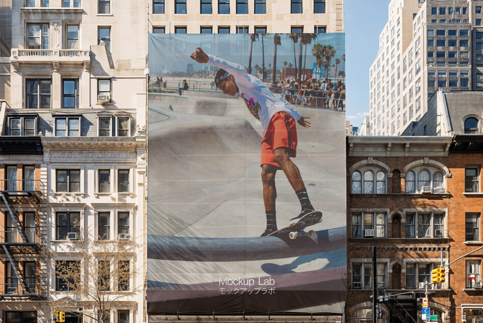 Street-side banner wrapping building facade with skateboarding action shot
