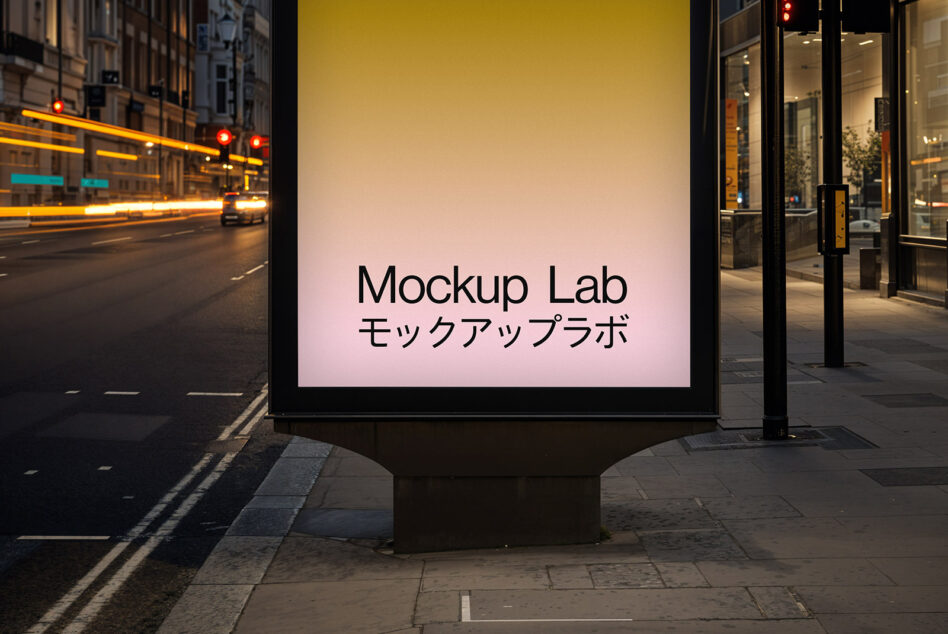 Lit outdoor billboard mockup at night on busy street with moving vehicles