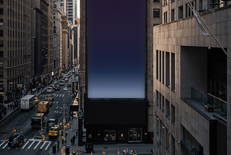 Urban billboard mockup at dusk with city street below, blue sky fading
