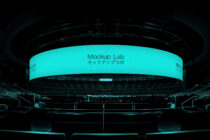 Indoor arena curved LED screen glowing cyan with Mockup Lab branding
