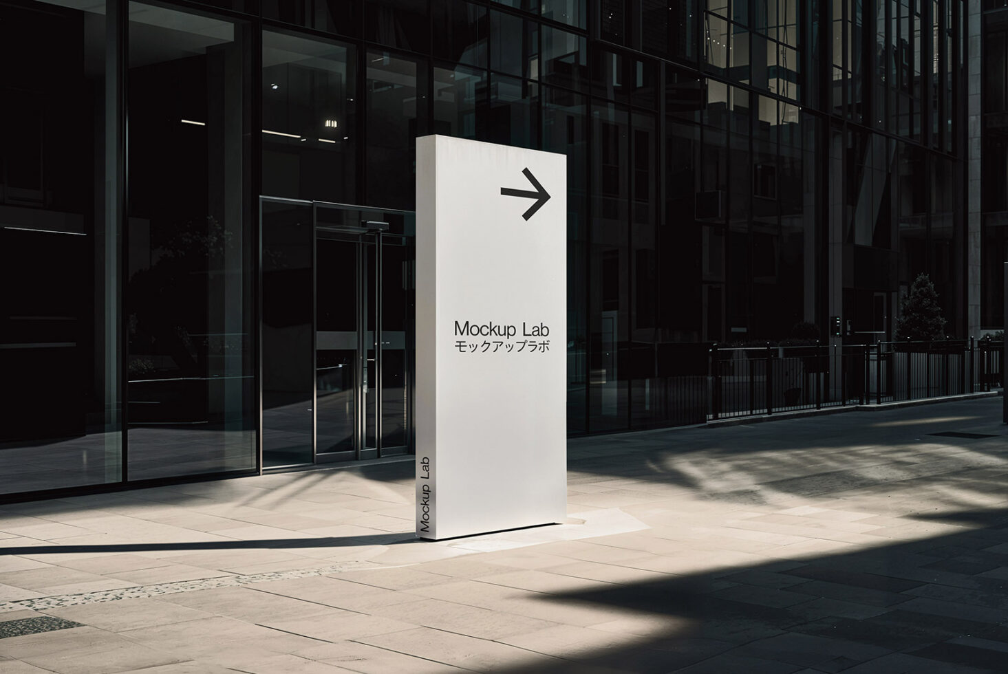 Modern outdoor signage mockup featuring a sleek metal sign with directional arrow in a contemporary urban setting ideal for design presentations.