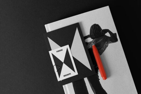 Mockup set featuring a black and white photo book with geometric design cards and a red pen. Perfect for designers seeking clean, modern layouts.