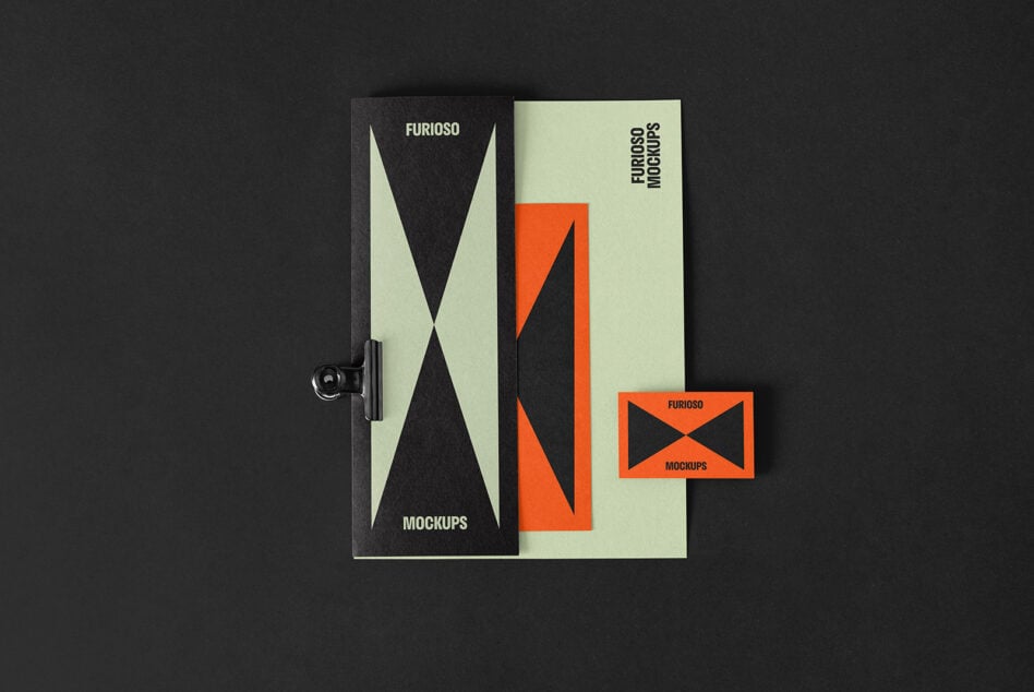 Top view of modern brochure design mockups featuring geometric patterns in black and orange on green paper laying on a black background suitable for designers