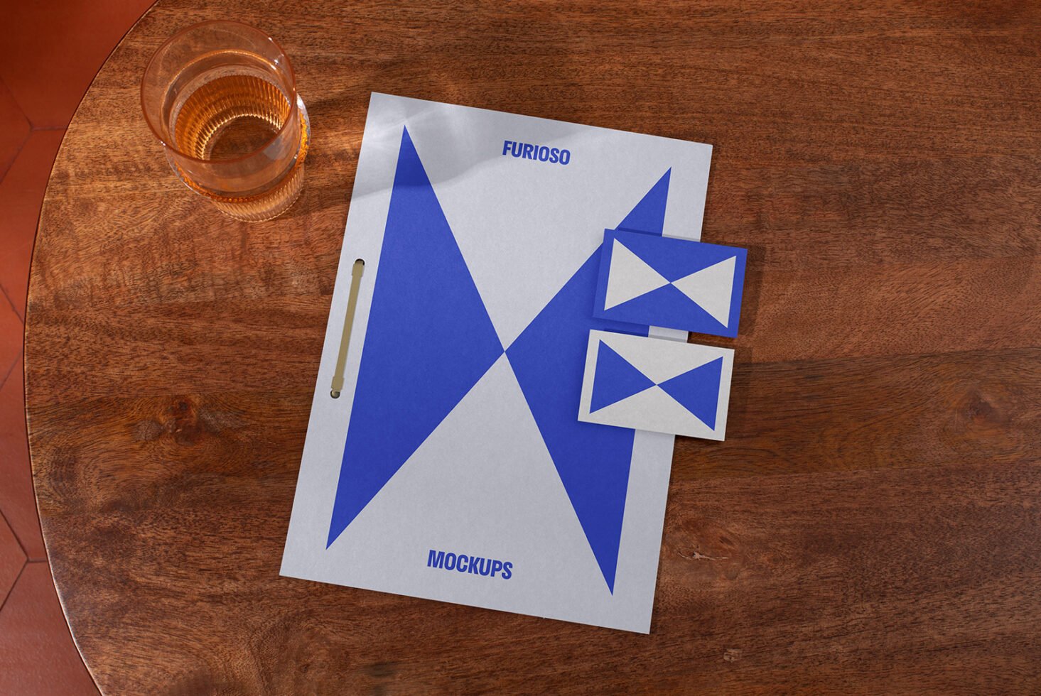 Stylish stationery mockup on wooden surface showcasing modern design with geometric patterns featuring folder and business cards ideal for graphic designers.