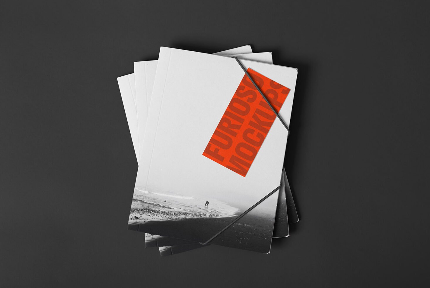 Minimalist mockup design featuring stacked brochures with bold orange typography on a black and white cover ideal for graphic designers and templates.