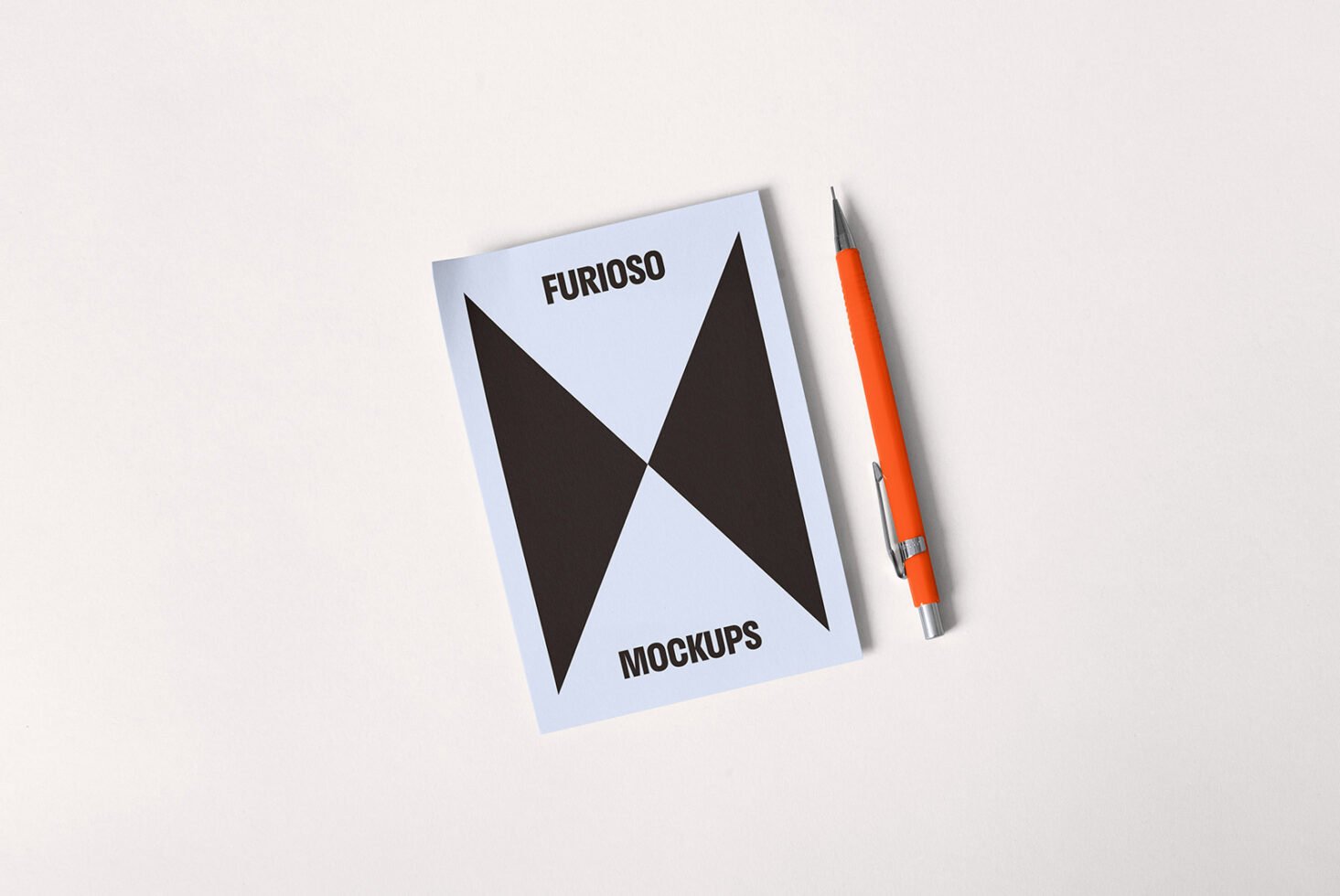 Mockup design featuring a notebook cover with geometric elements next to an orange pen on a light background suitable for graphic designers.