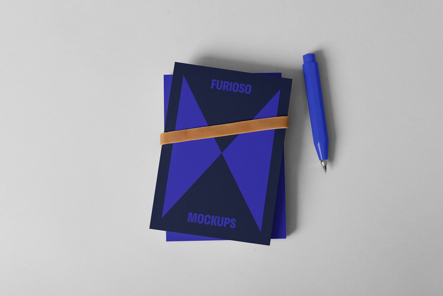 Blue mockup cards with geometric design tied with a band and a blue pen beside them. Ideal for designers needing stylish presentation graphics.