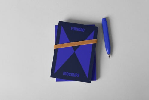 Blue mockup cards with geometric design tied with a band and a blue pen beside them. Ideal for designers needing stylish presentation graphics.