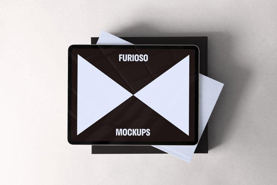 Tablet showing a minimalist mockup design on a gray surface, ideal for designers seeking sleek digital assets. Keywords: Mockups, Design, Tablet.