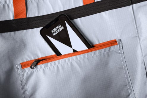 Mockup of smartphone in a gray and orange zippered pocket. Ideal for design presentations. Keywords: smartphone mockup graphic design template.