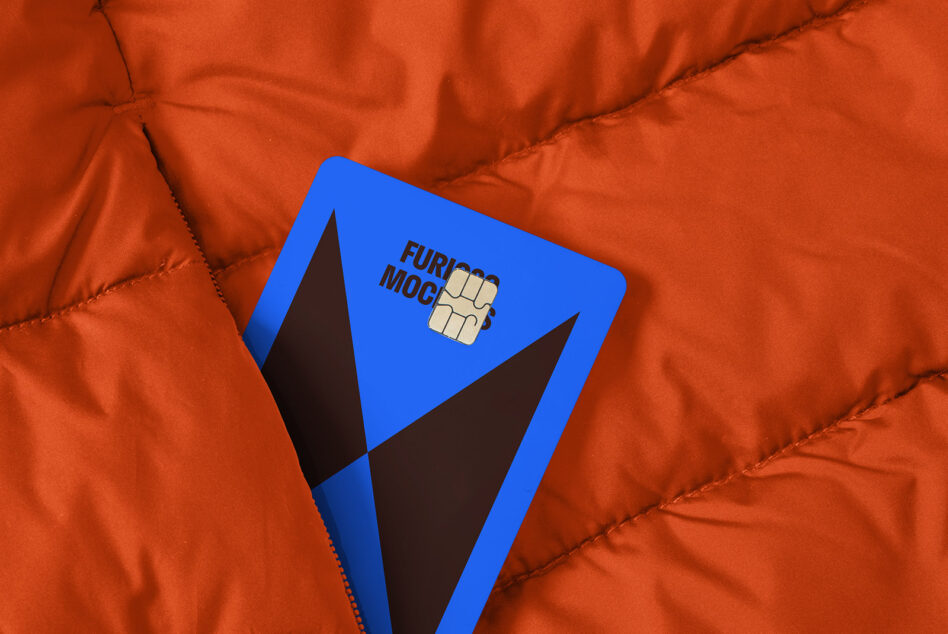 Blue card mockup with geometric design partially tucked in orange quilted fabric. Ideal for graphic designers, digital assets, and brand presentations.