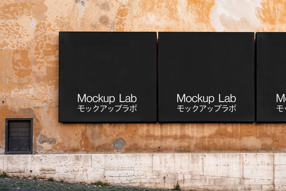 Two black wall-mounted signs on distressed terracotta brick wall