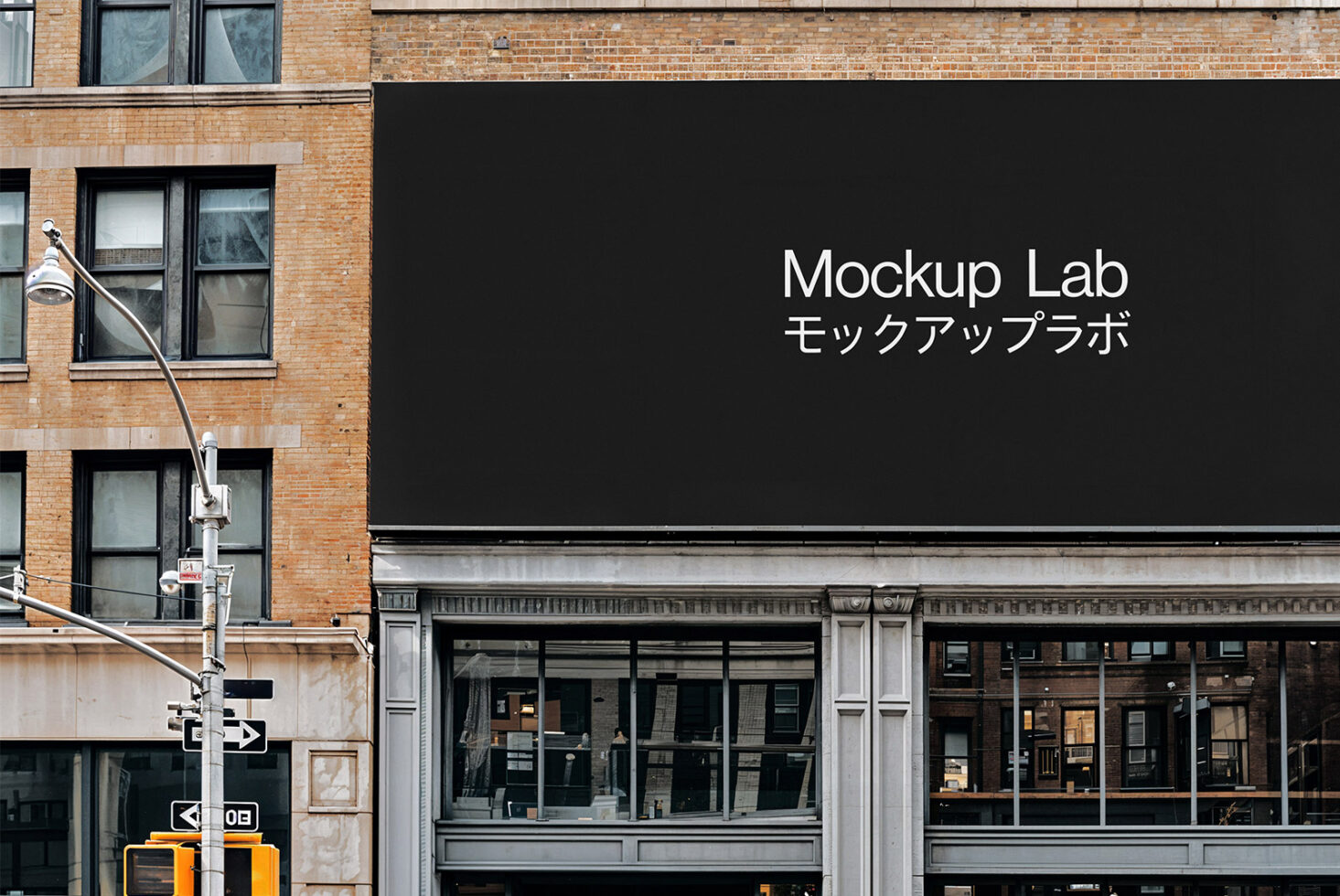 Urban mockup of a large blank black billboard on brick building; perfect for showcasing advertisements or branding in a realistic street environment.