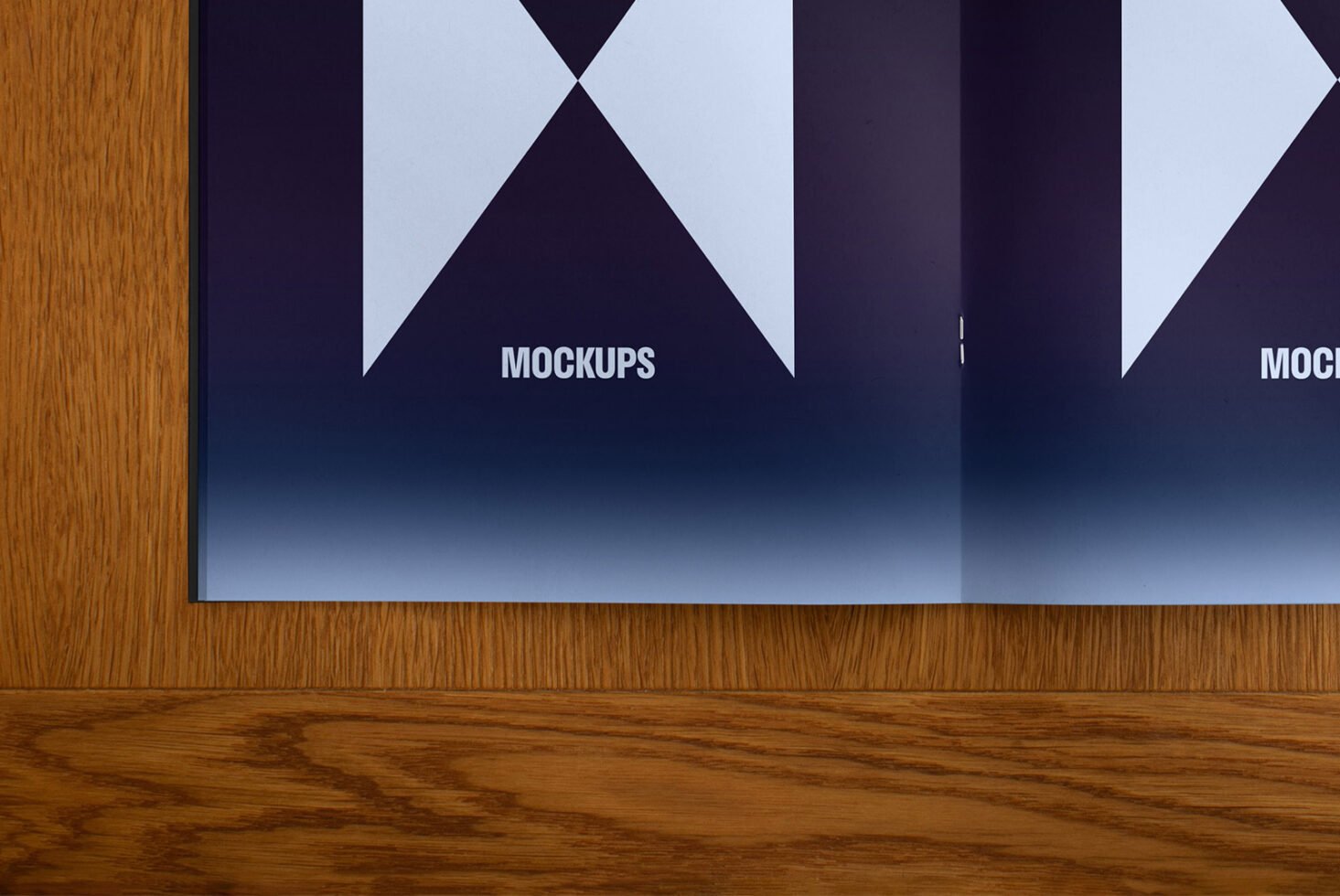 Open book mockup on wooden surface featuring modern geometric design in white and navy blue ideal for designers seeking high-quality presentation templates.