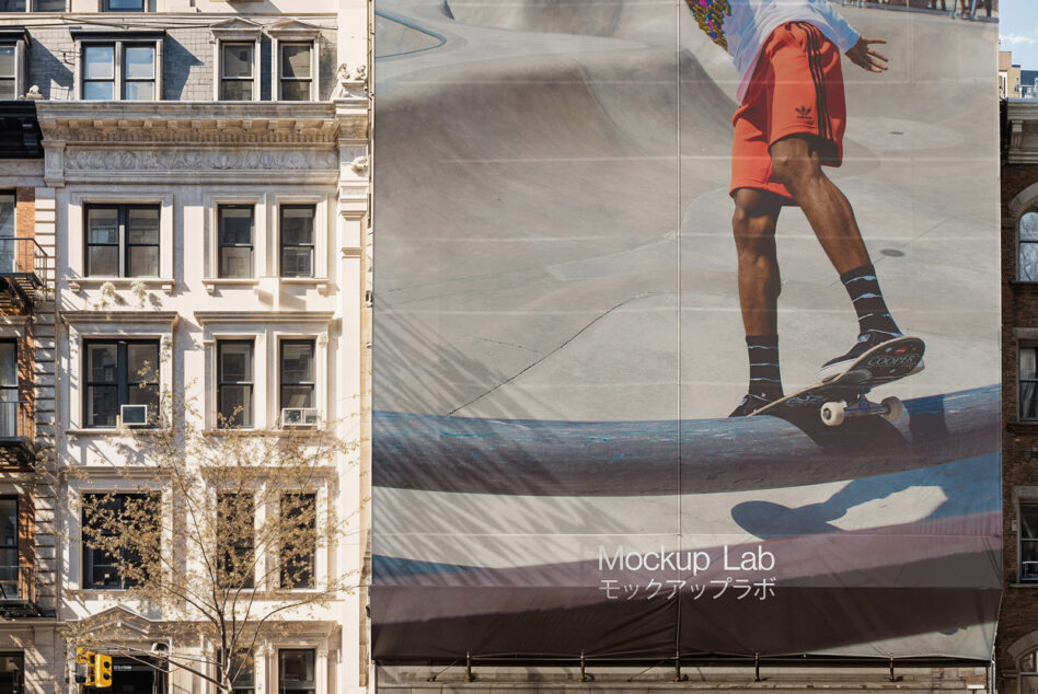 Large fabric banner on building showing skateboarder in red jacket