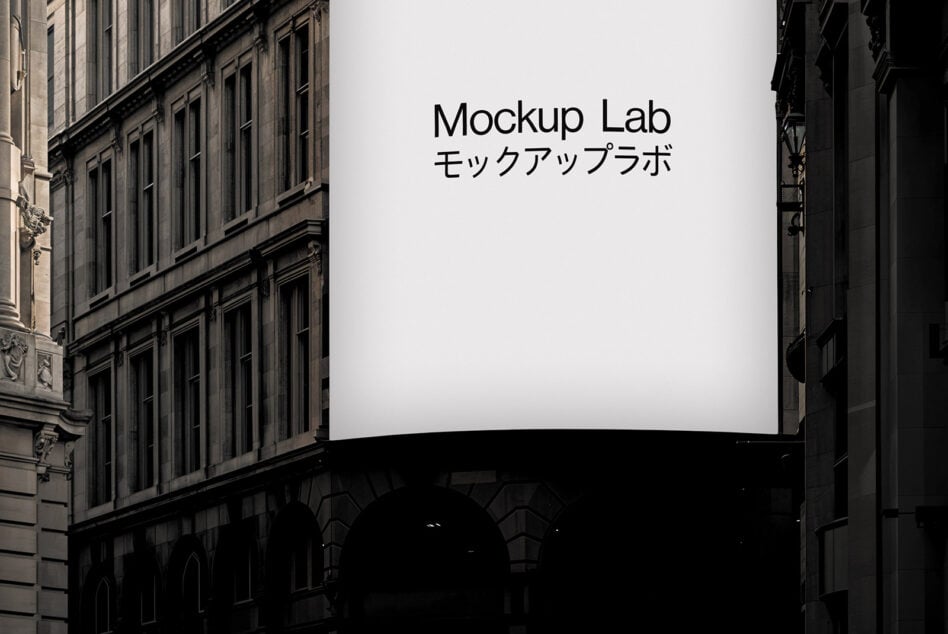 Curved billboard between stone buildings showing Mockup Lab text in black