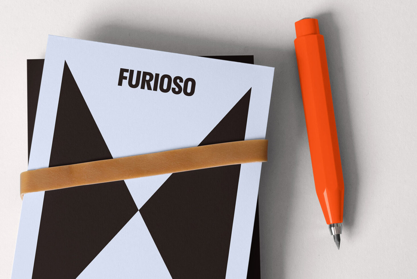 Minimalist graphic design mockup featuring geometric patterns and a stylish modern font Furioso. Includes an orange pen and rubber band. Ideal for designers.