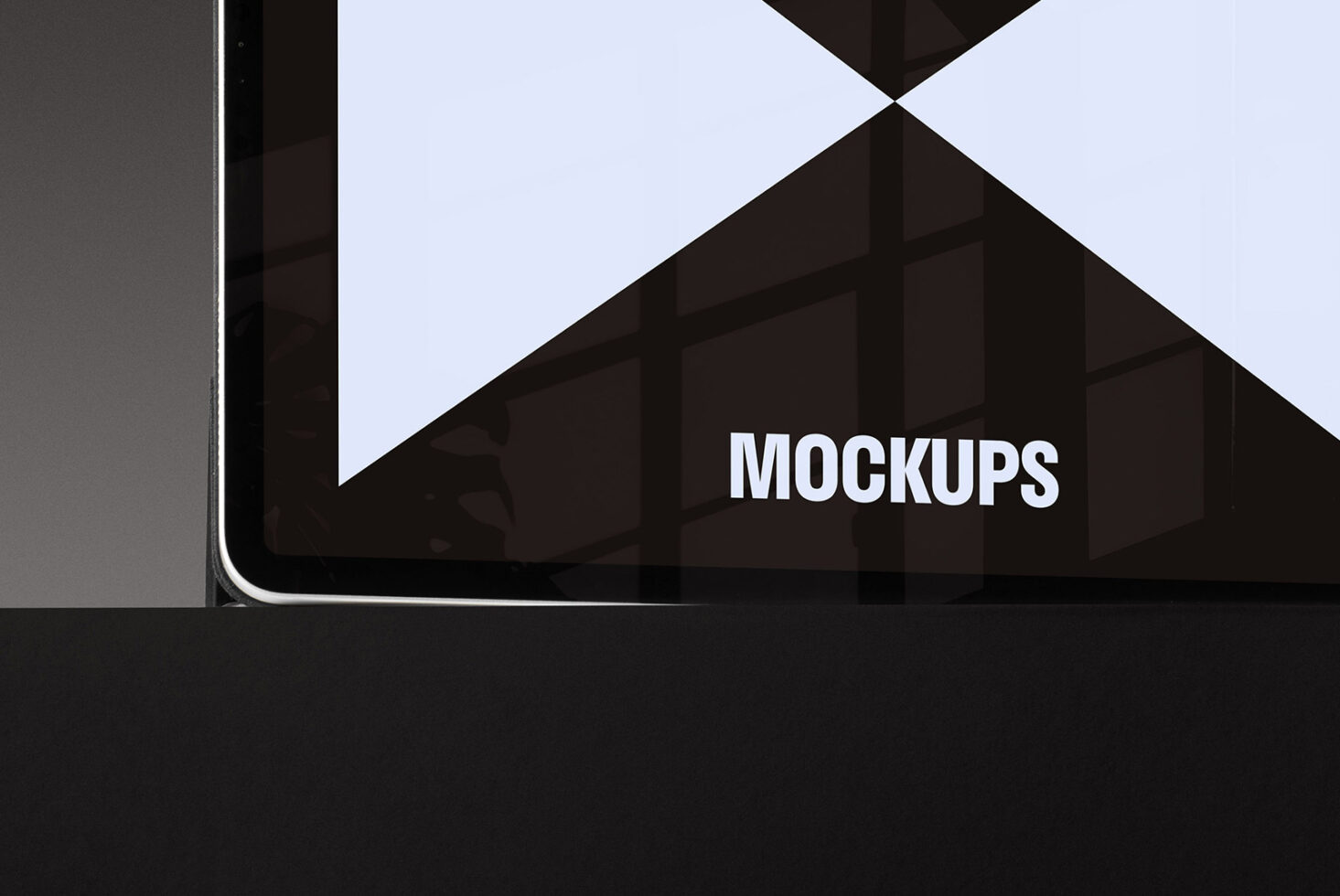 Tablet with black screen showing word Mockups. Ideal for designers seeking digital mockup templates. Showcase designs on realistic devices for marketing.