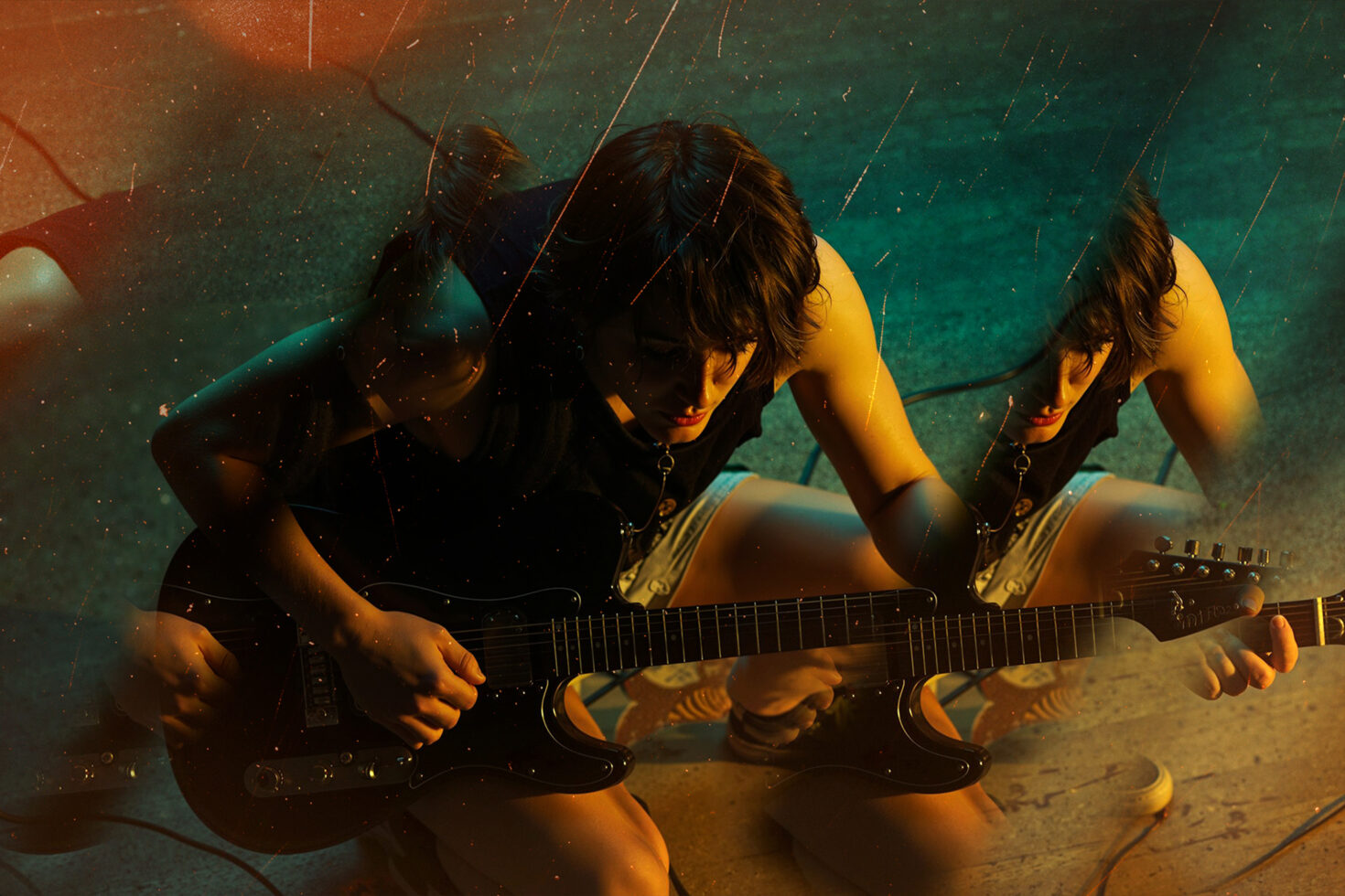 Woman playing electric guitar rain effect teal orange color grade