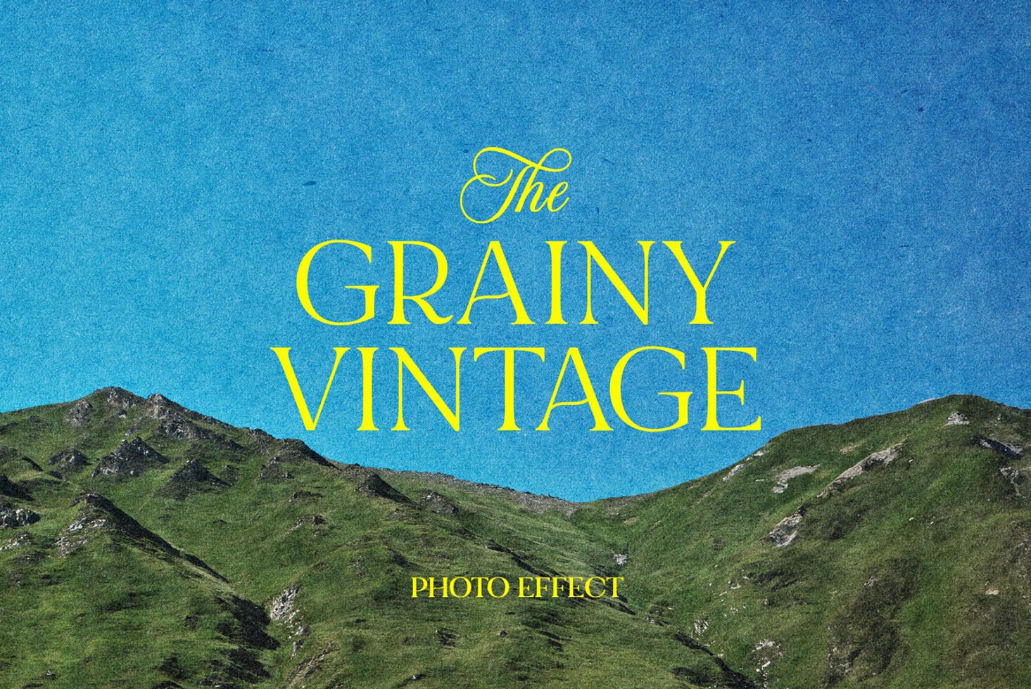 Vintage photo effect with grainy texture over a mountain landscape under a clear blue sky keywords: mockups graphics templates designers.
