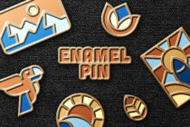 Enamel pin collection scattered showing mountains lotus flowers symbols